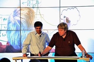 Two men collaborating on an electronic whiteboard