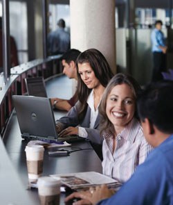People in coffee shop using wifi laptops
