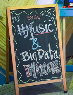 Chalk board sign that says SXSW Music and Big Data Mixer