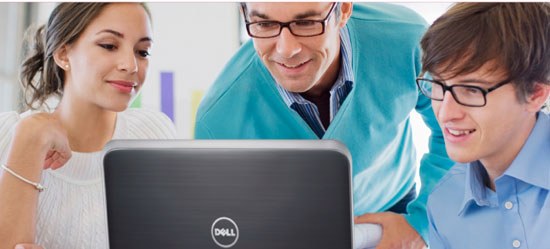 three people look at something on a Dell laptop