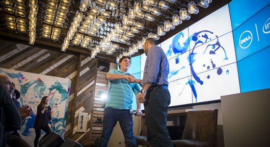  Frank Azor of Alienware and Palmer Luckey of Oculus shake hands on stage at the Dell space at CES 2016
