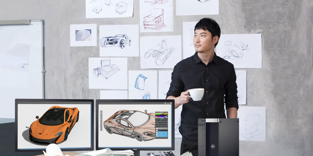 man drinking coffee in design office with dell monitors