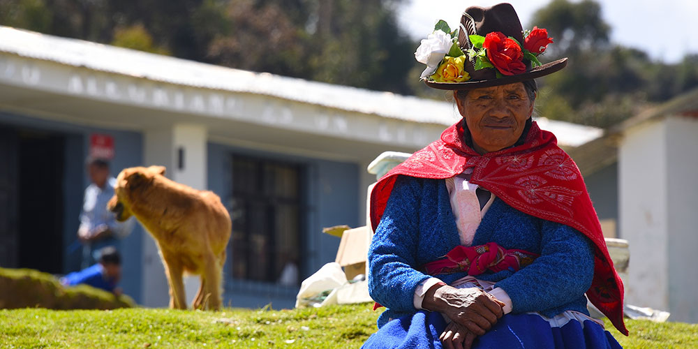 woman sitting outside home in Peru