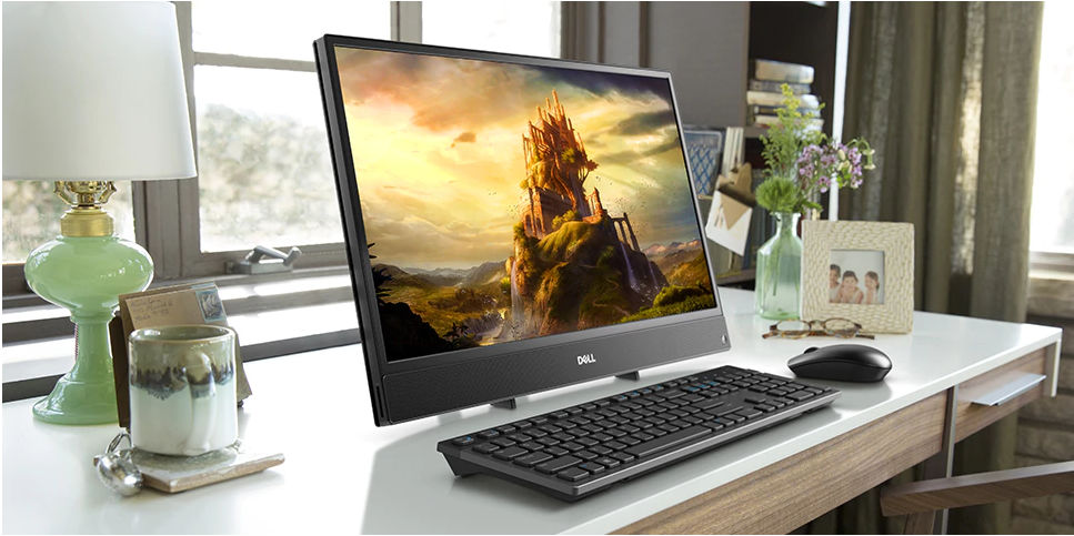 Dell Inspiron all-in-one desktop computer sitting on a home office desk with a video game on the display